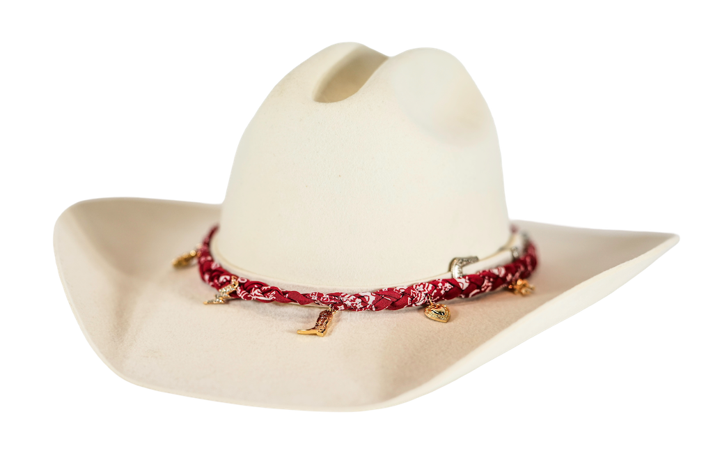 A cream-colored cowboy hat with a red and white patterned bandana-style hatband decorated with small gold-toned metal accents, shown on a plain white background.