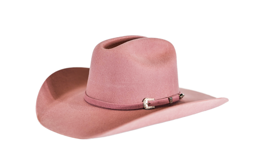 A dusty rose pink felt cowboy hat with a matching band and a silver-colored metal buckle, shown against a plain white background.